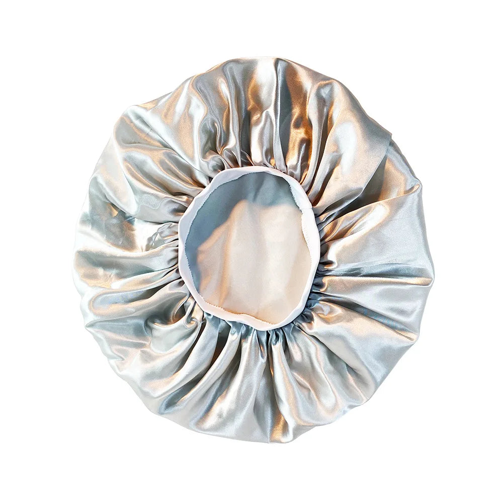 Metallic silver shower cap on a white background