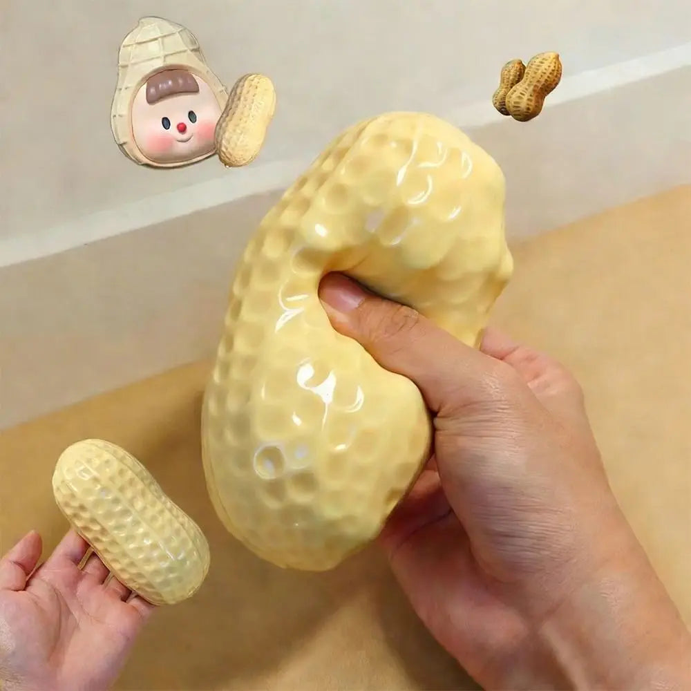 Hand squeezing a jumbo peanut-shaped slow-rising squishy stress relief toy with a small peanut squishy and cute peanut character, sensory fidget toy for anxiety relief, ADHD focus, autism support, office desk stress relief, and hand exercise. Squishy Toy