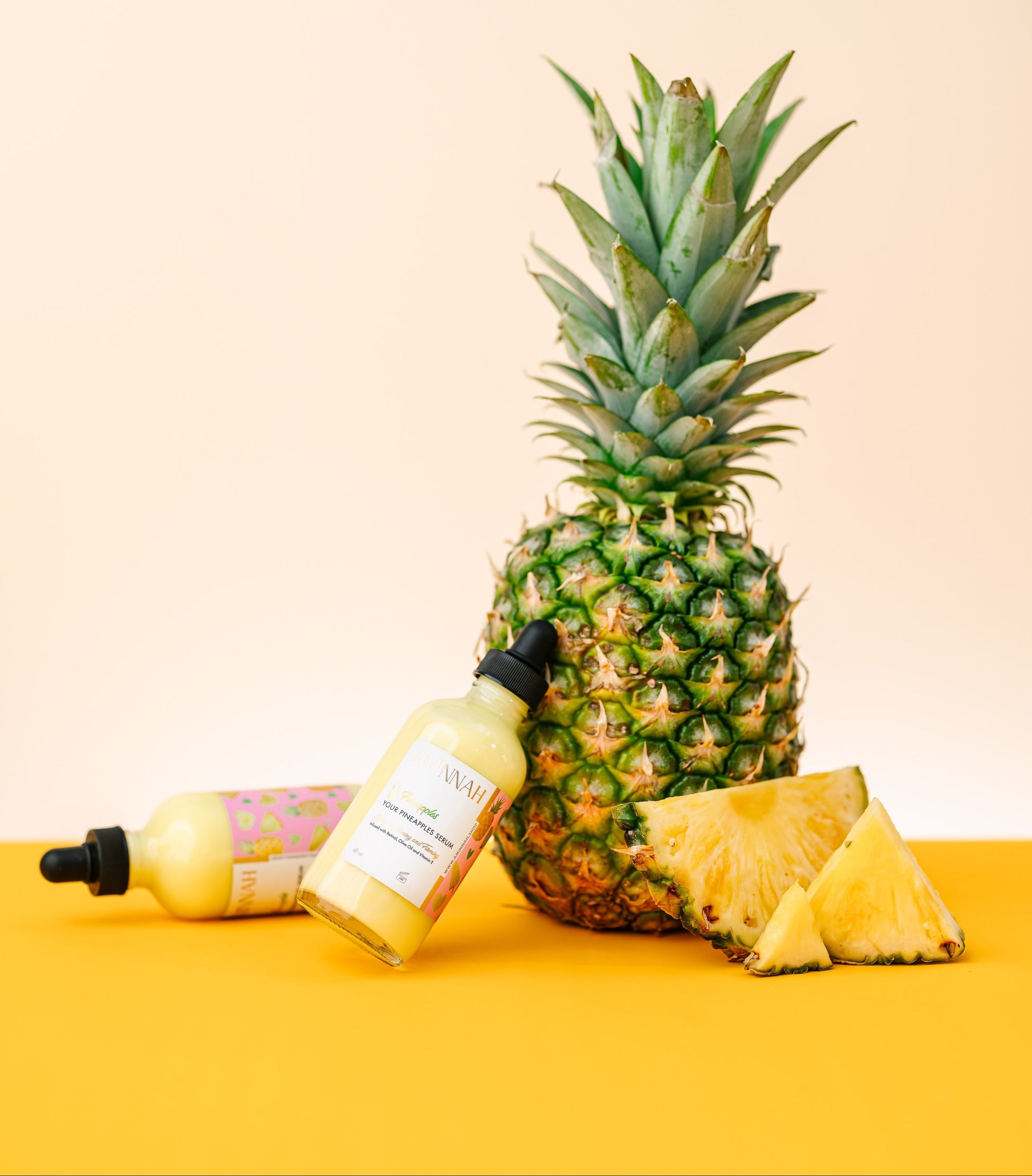 Pineapple and skincare products on a yellow background