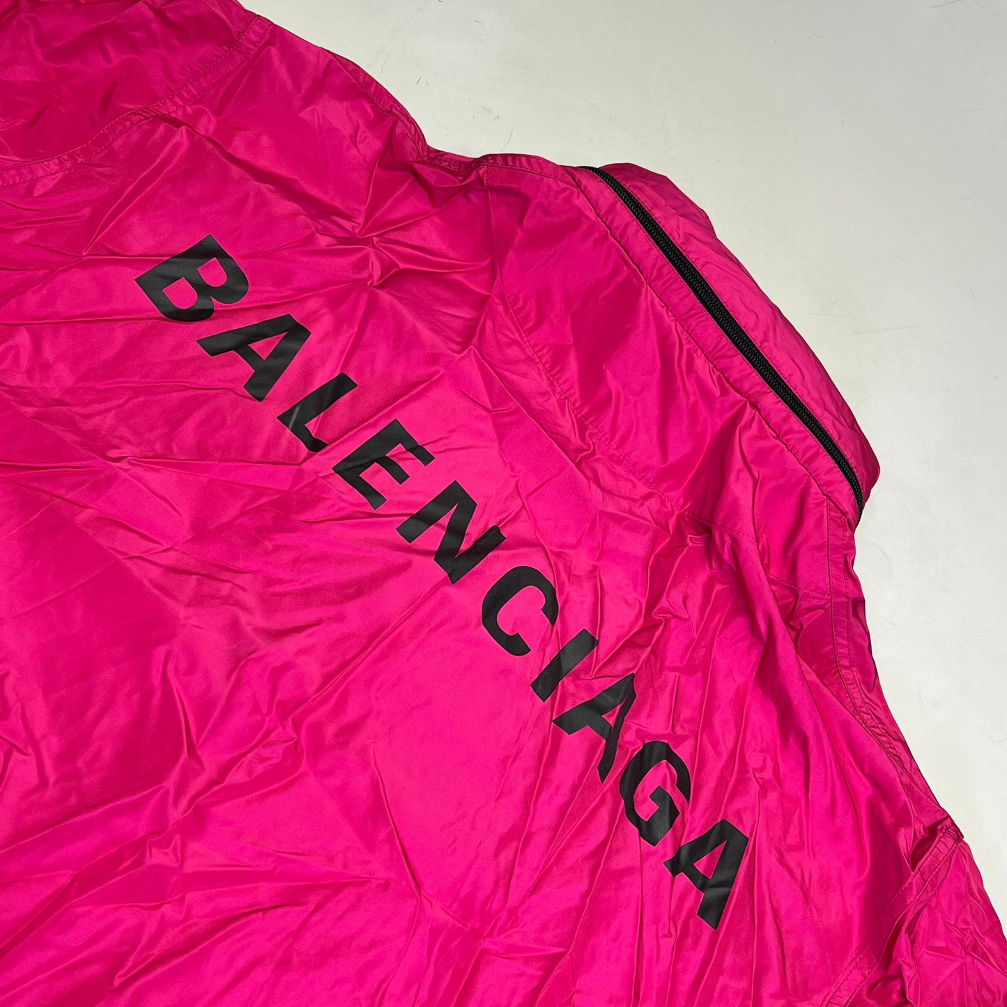 Pink jacket with 'BALENCIAGA' branding on a white background