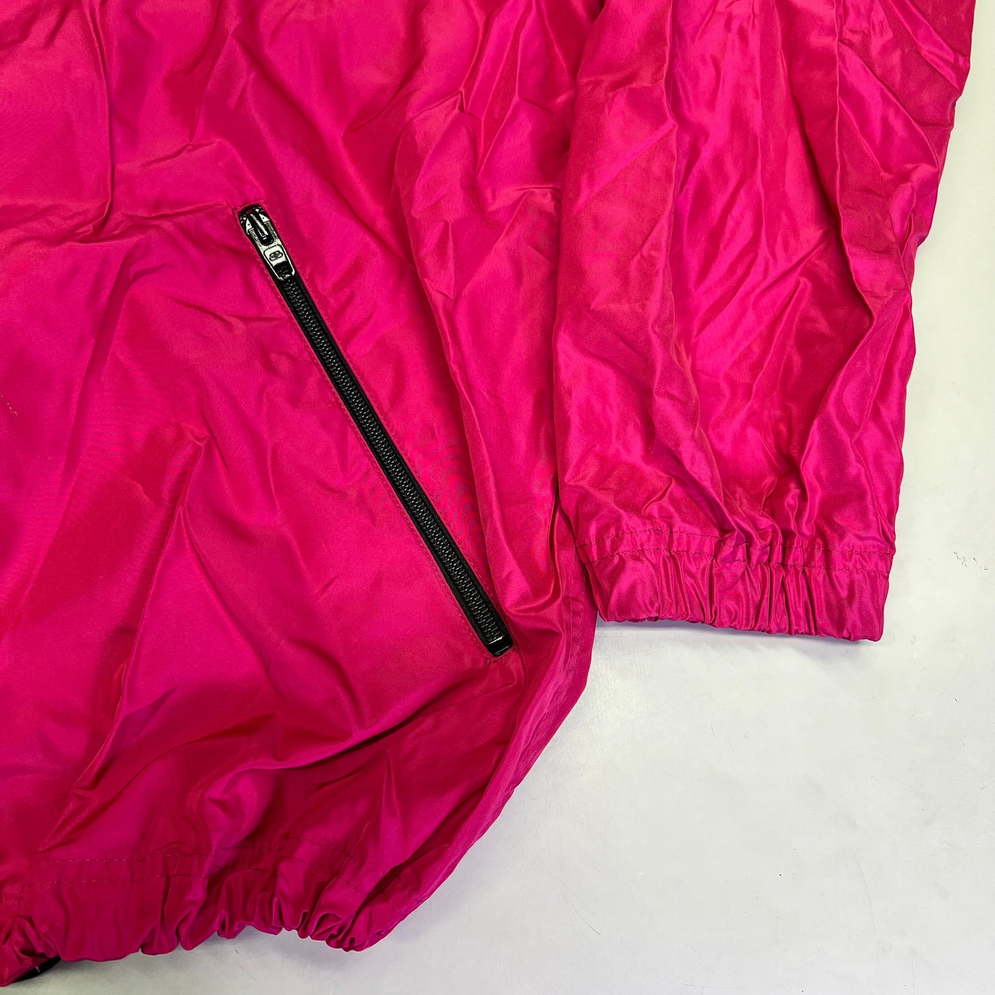 Pink jacket with a black zipper on a white background