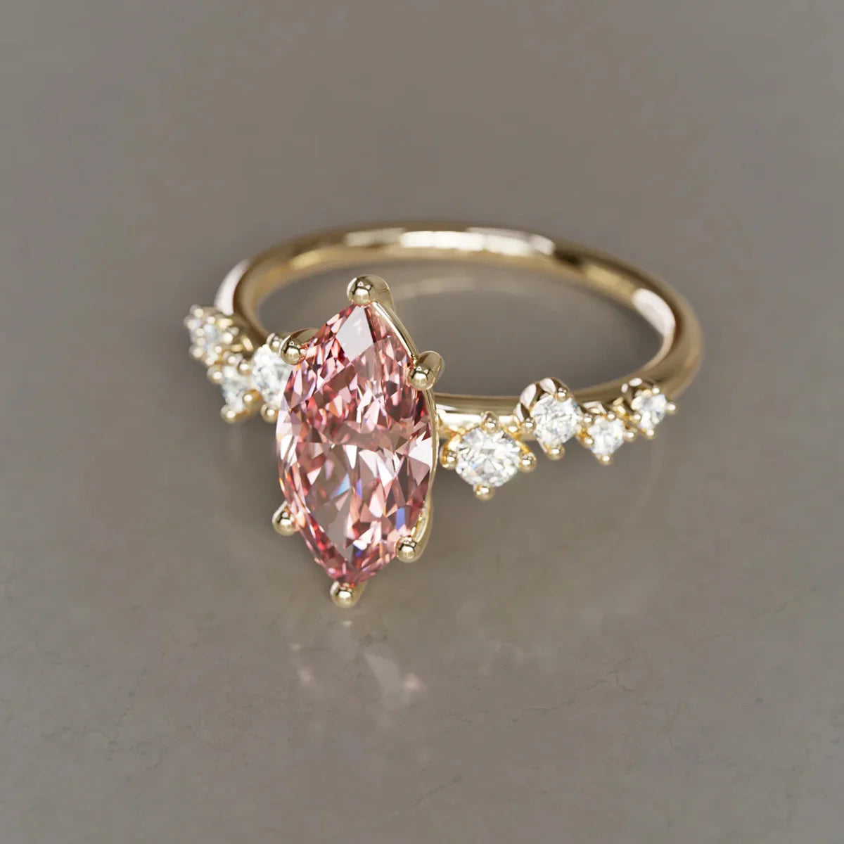 Gold ring with a pink gemstone and smaller diamonds. Pink Marquise Lab Grown Diamond Flower Ring in 9K / 14K / 18K Yellow Gold

Delicate, romantic, and endlessly feminine, this pink marquise lab grown diamond ring blooms like a tiny flower on your finger. Crafted in your choice of 9K, 14K, or 18K yellow gold, it’s the perfect symbol of love and tenderness — an unforgettable Valentine’s gift or a meaningful treat just for you.

The soft pink sparkle of the marquise-cut lab diamond, arranged in graceful flow