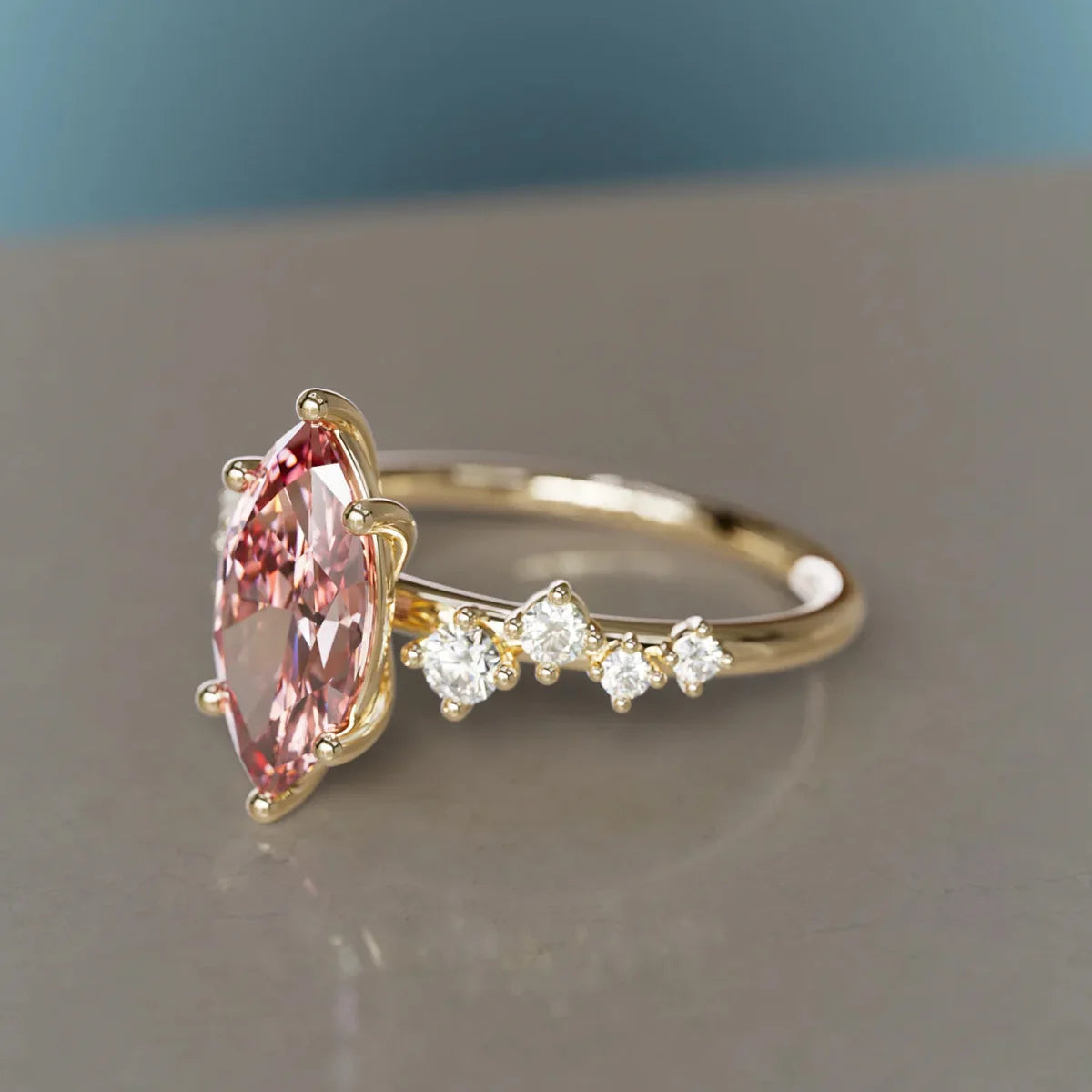 Gold ring with a pink gemstone and smaller diamonds on a reflective surface. Pink Marquise Lab Grown Diamond Flower Ring in 9K / 14K / 18K Yellow Gold

Delicate, romantic, and endlessly feminine, this pink marquise lab grown diamond ring blooms like a tiny flower on your finger. Crafted in your choice of 9K, 14K, or 18K yellow gold, it’s the perfect symbol of love and tenderness — an unforgettable Valentine’s gift or a meaningful treat just for you.