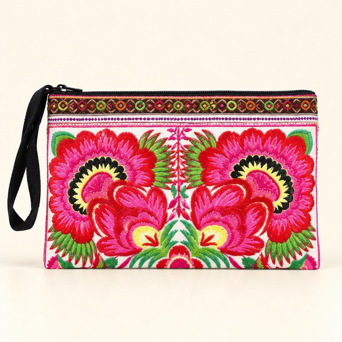 A rectangular embroidered clutch bag with a black zipper and black wrist strap, featuring a vibrant pink, red, green, and yellow floral pattern on a cream background.