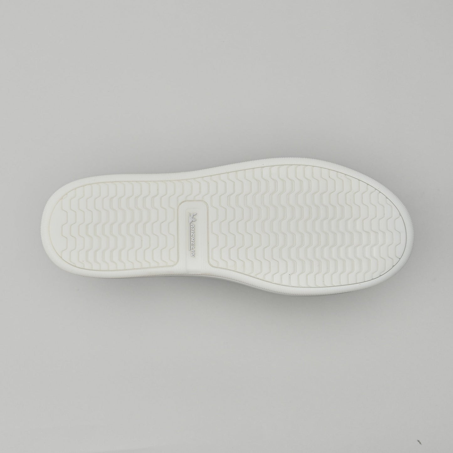 White shoe sole on a gray background