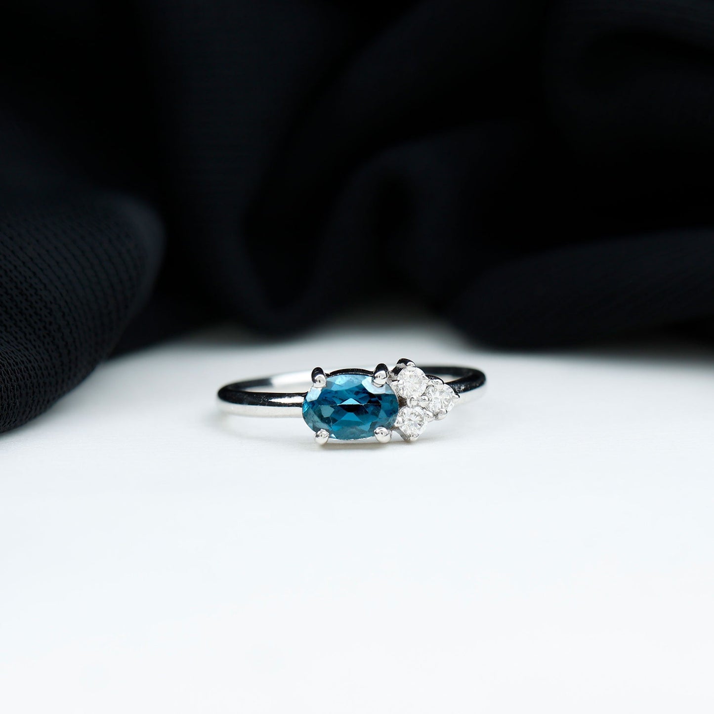 4X6mm Oval Cut London Blue Topaz East West Promise Ring with Diamond Trio