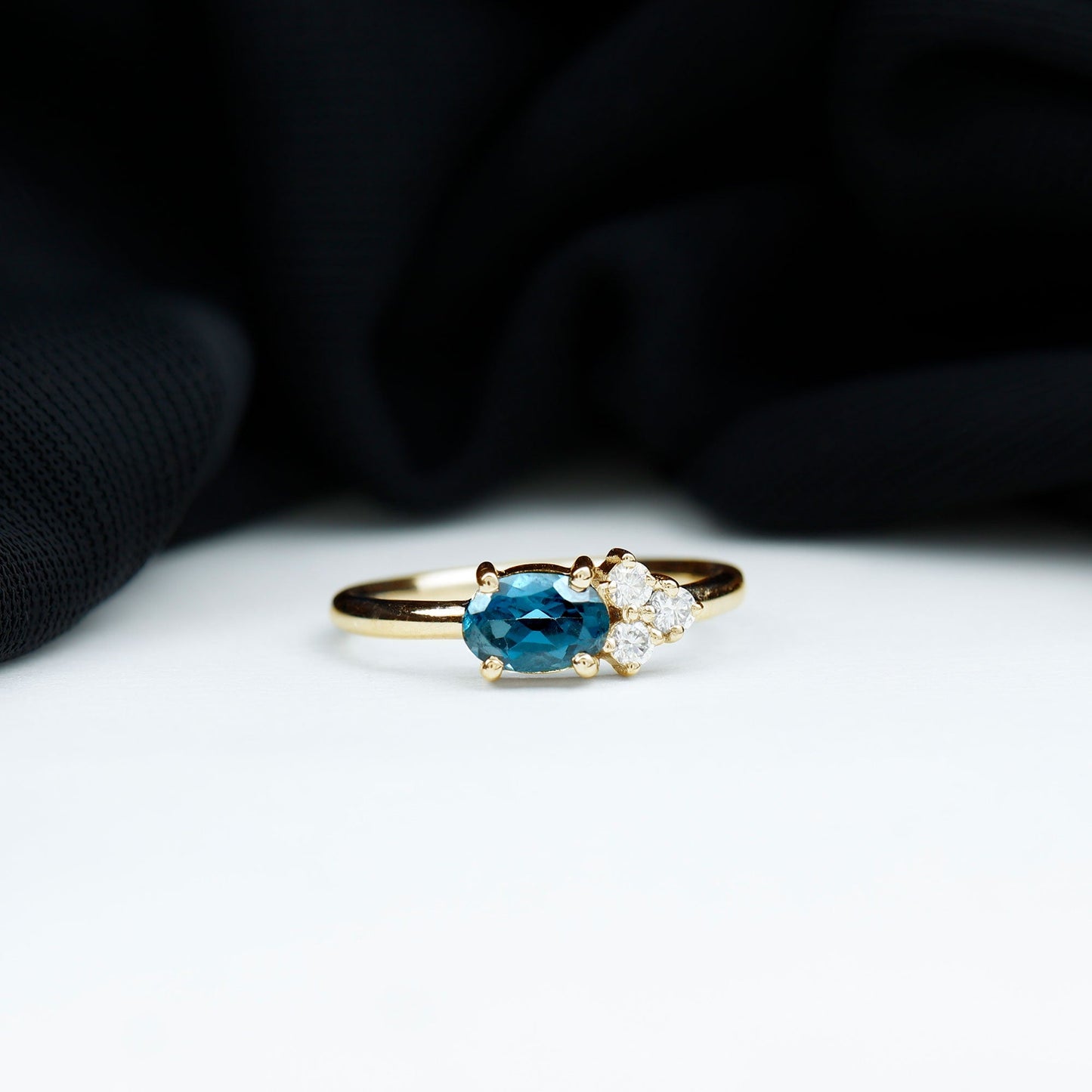 4X6mm Oval Cut London Blue Topaz East West Promise Ring with Diamond Trio
