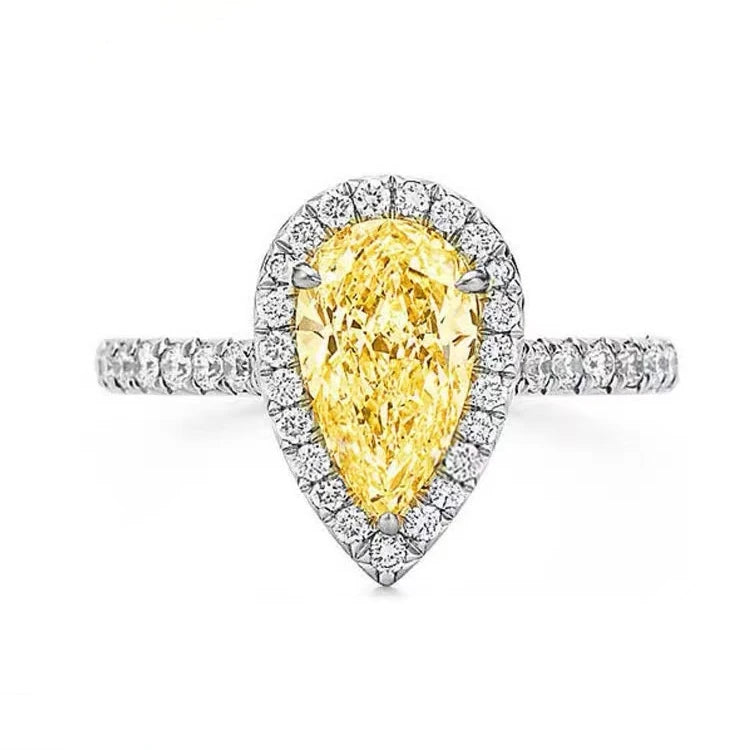 Ring with a yellow pear-shaped diamond and diamond halo on a white background Yellow diamond ring with silver setting on a hand 14k Gold 3.5ct Moissanite Jewelry Diamond Ring A bold, architectural silhouette with a “camera-flash” kind of brilliance.  YELLOW DIAMONDS