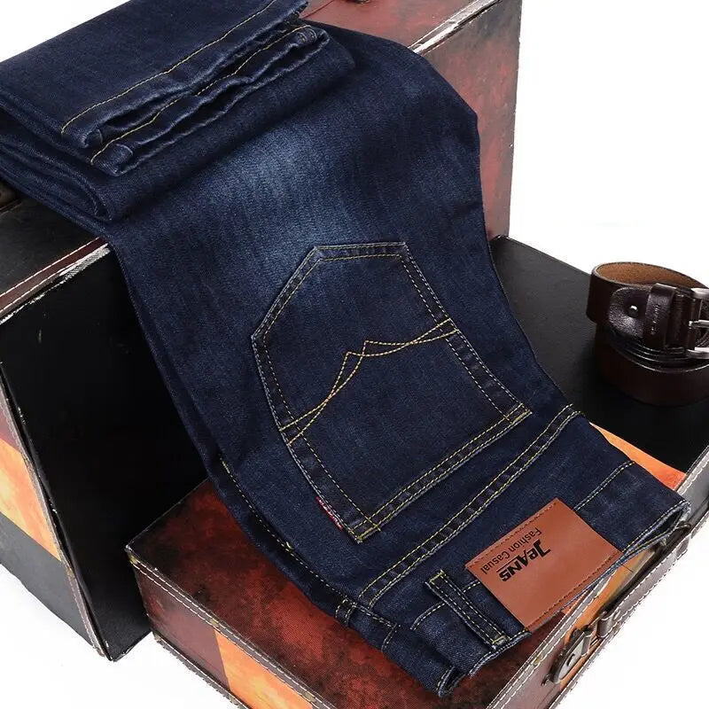 Folded blue jeans with a label on a wooden surface