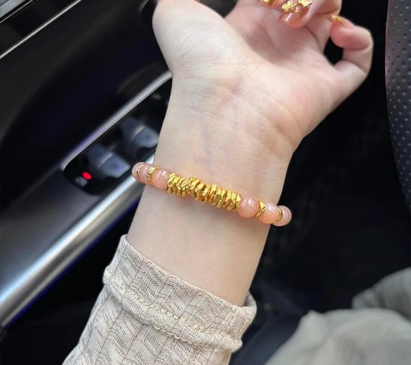 Gold bracelet on a wrist with a car interior background
