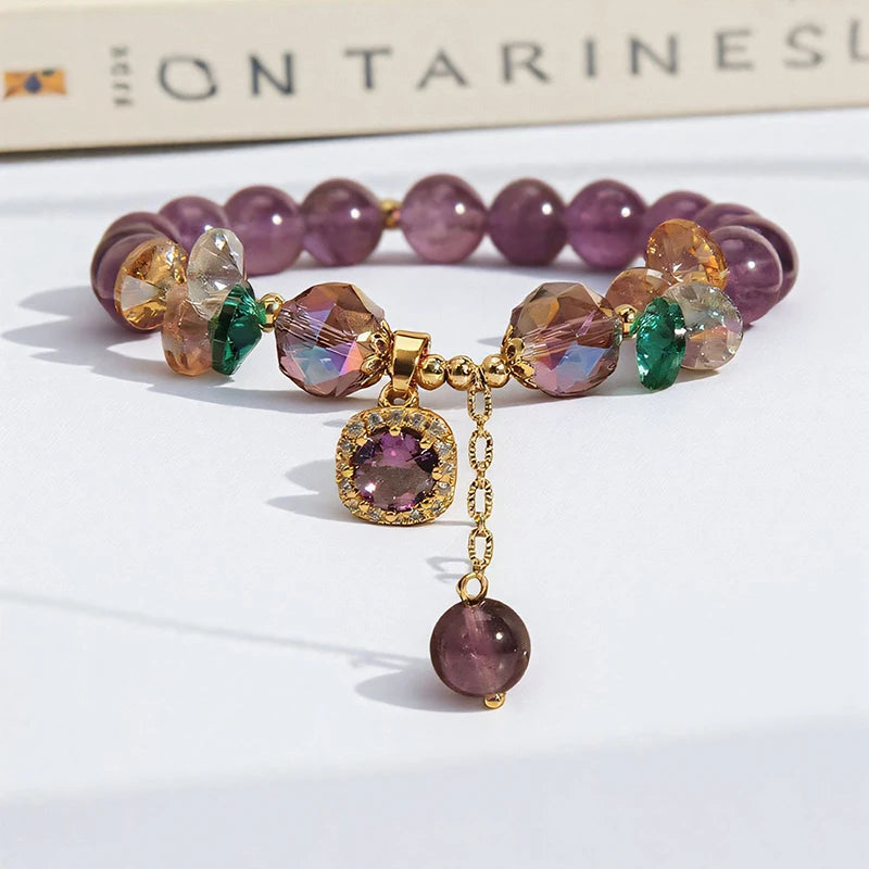 Multicolored beaded bracelet with a gold charm on a white surface