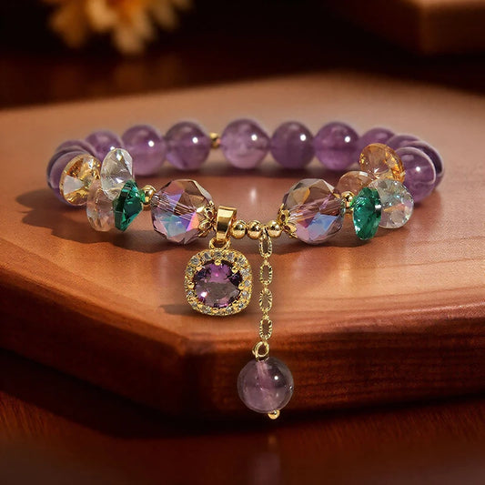 Multicolored beaded bracelet with a gold charm on a wooden surface
