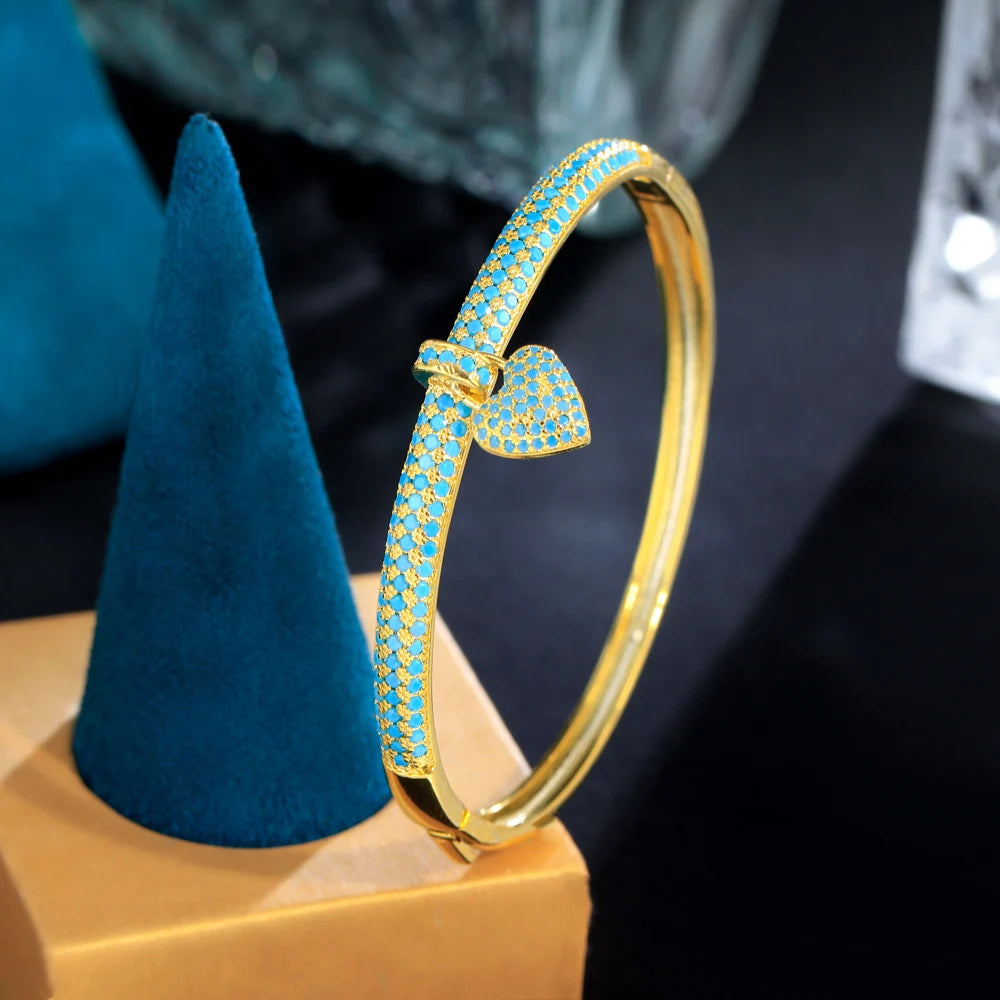 ThreeGraces Elegant Light Blue Cubic Zirconia Gold Color Small Heart Charm Luxury Open Cuff Bangle for Women Party Jewelry B080