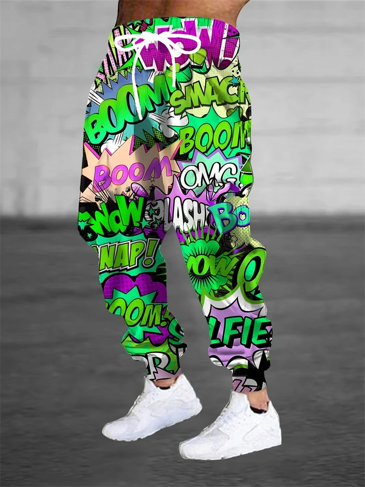 Colorful graphic pants with comic book text design worn by a person on a gray background