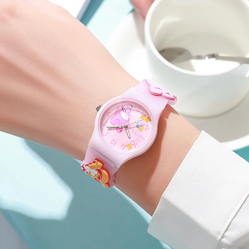 Pink children's watch with cartoon design on a wrist, blurred background