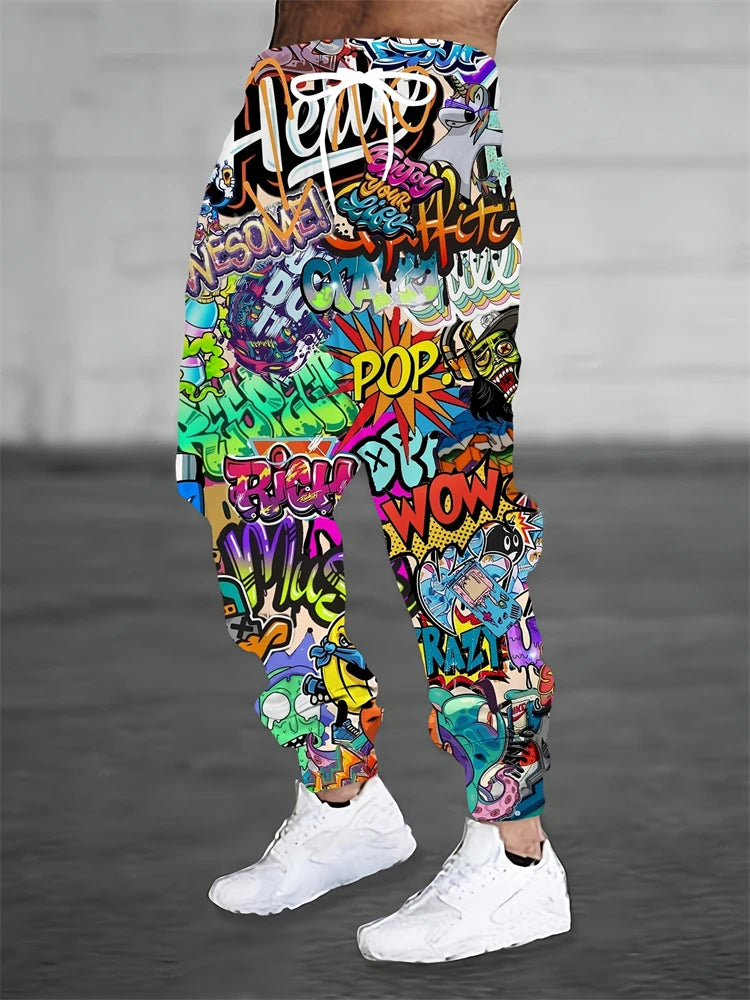 Colorful graffiti-style pants with text worn by a person on a gray background