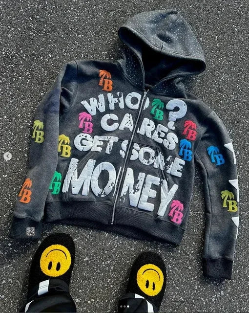 Black hoodie with colorful text and graphics on a textured surface