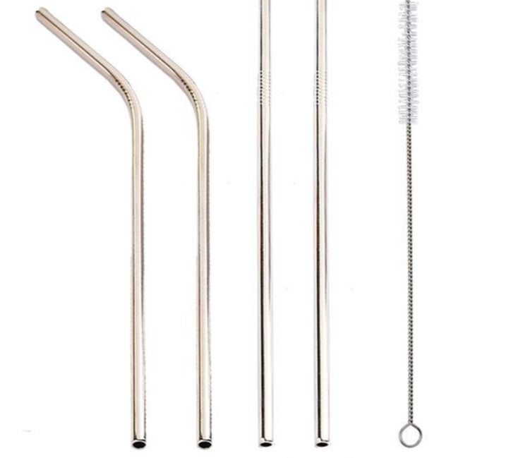 Set of metal straws and cleaning brush on a white background