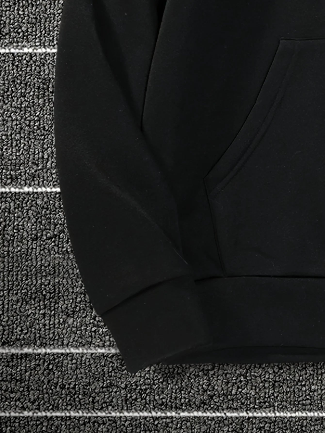 Black fabric on a textured gray surface