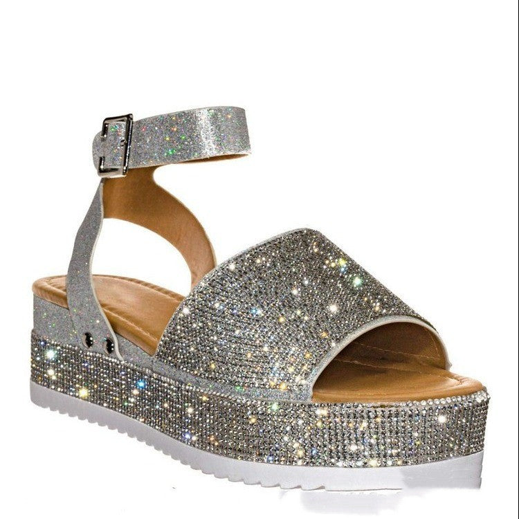 Silver glittery sandal with a platform sole on a white background