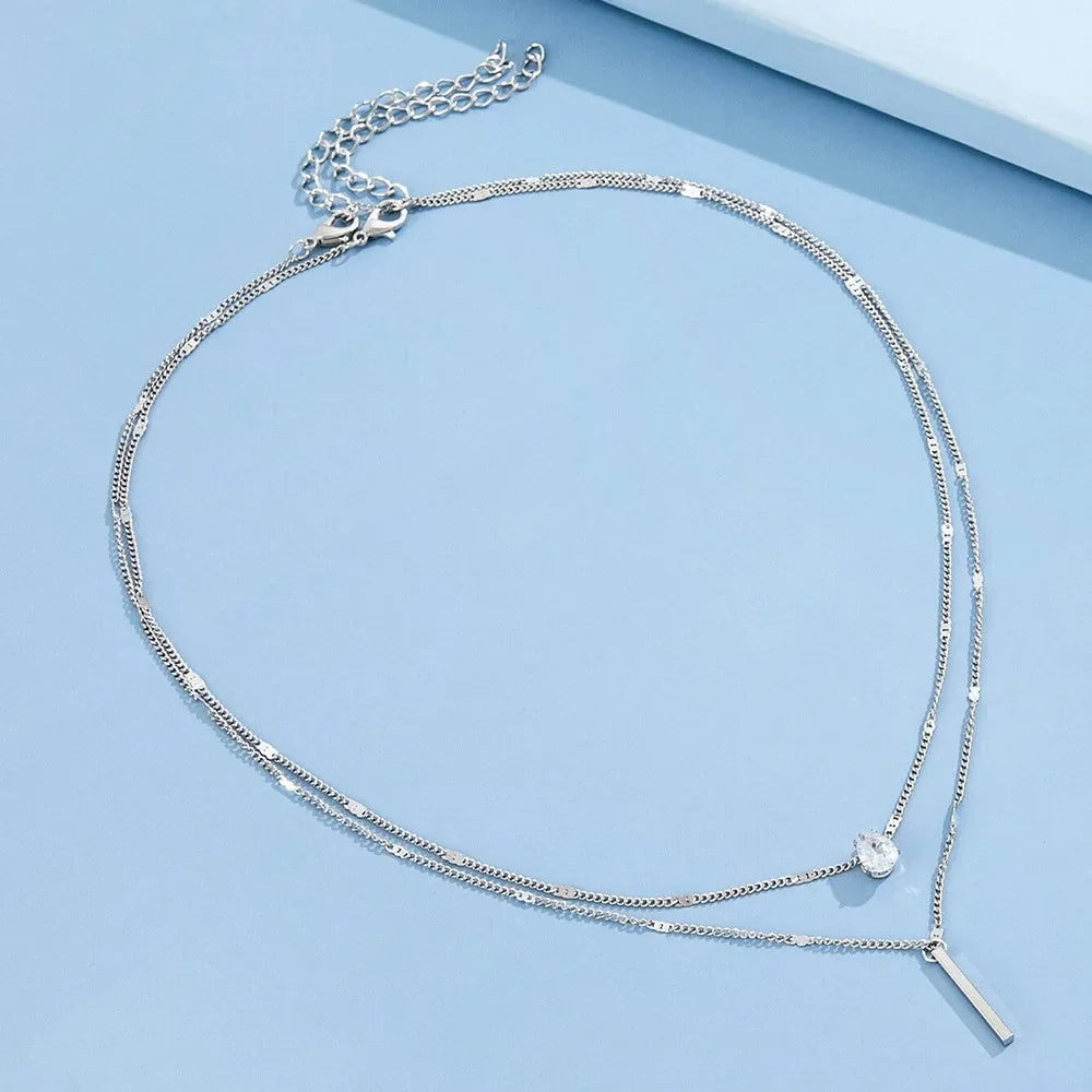 Silver necklace on a light blue background