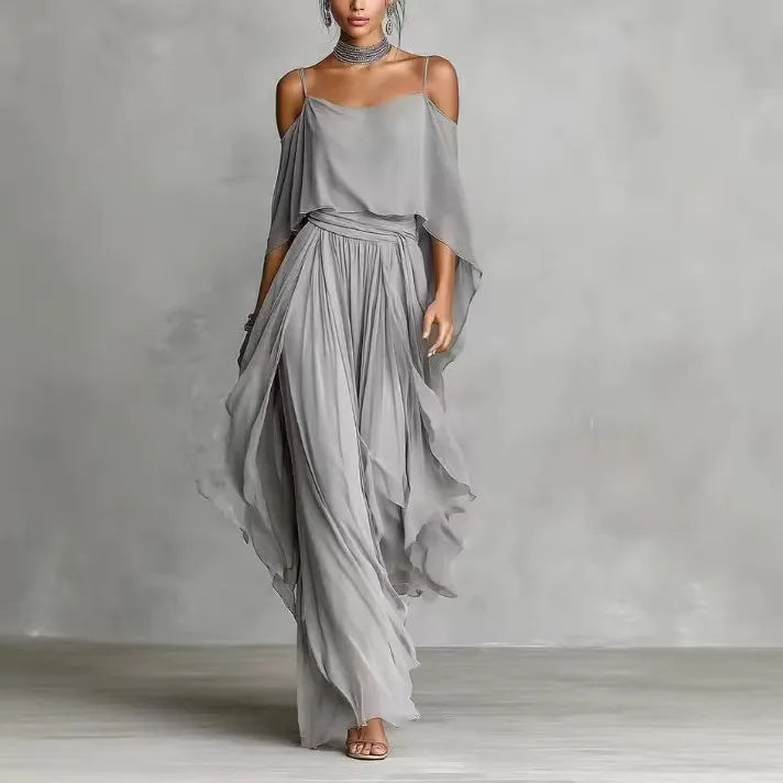 Flowing gray chiffon women's two-piece co-ord set featuring an asymmetrical cold-shoulder camisole top and wide-leg full-length pants, elegant resort wear outfit for beach vacations, weddings, parties, and special occasions.