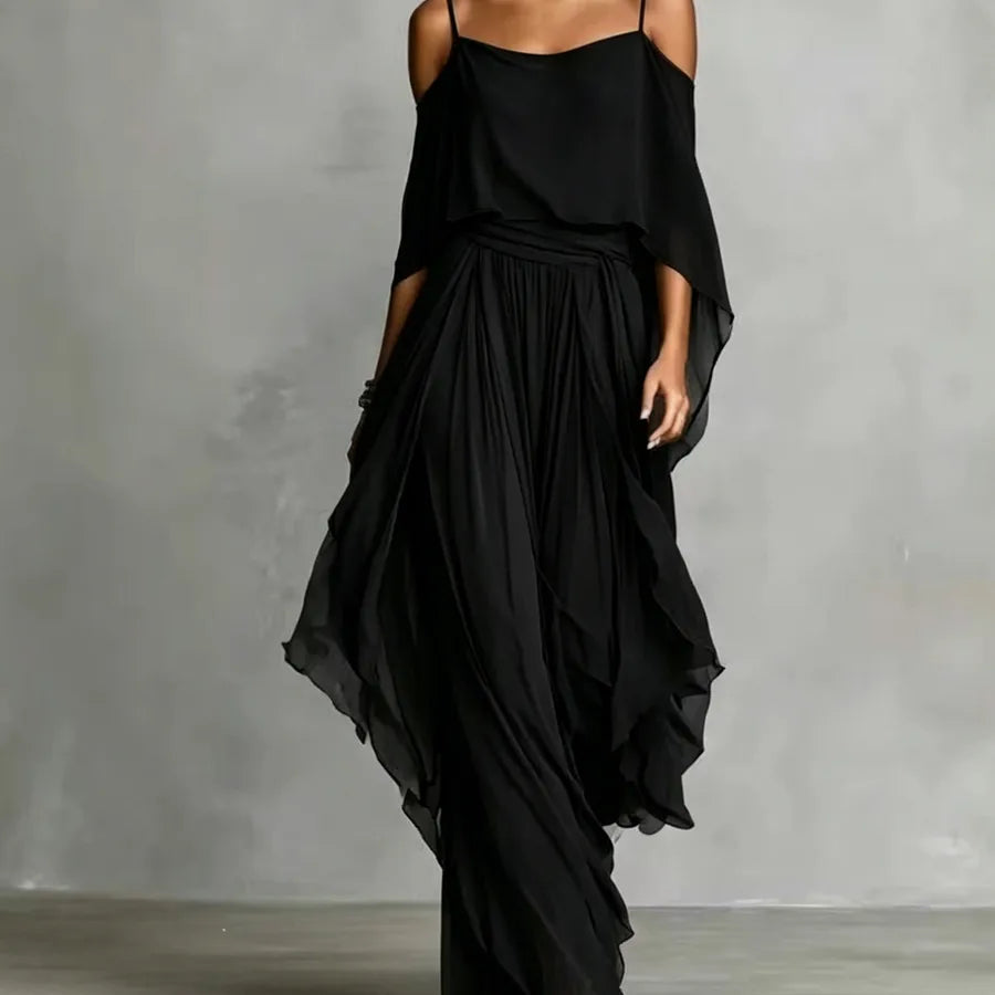 Black off-shoulder chiffon two-piece pants set for women with asymmetrical camisole top, wide-leg flowy pants, elegant resort wear, beach vacation outfit, evening party fashion in solid black.