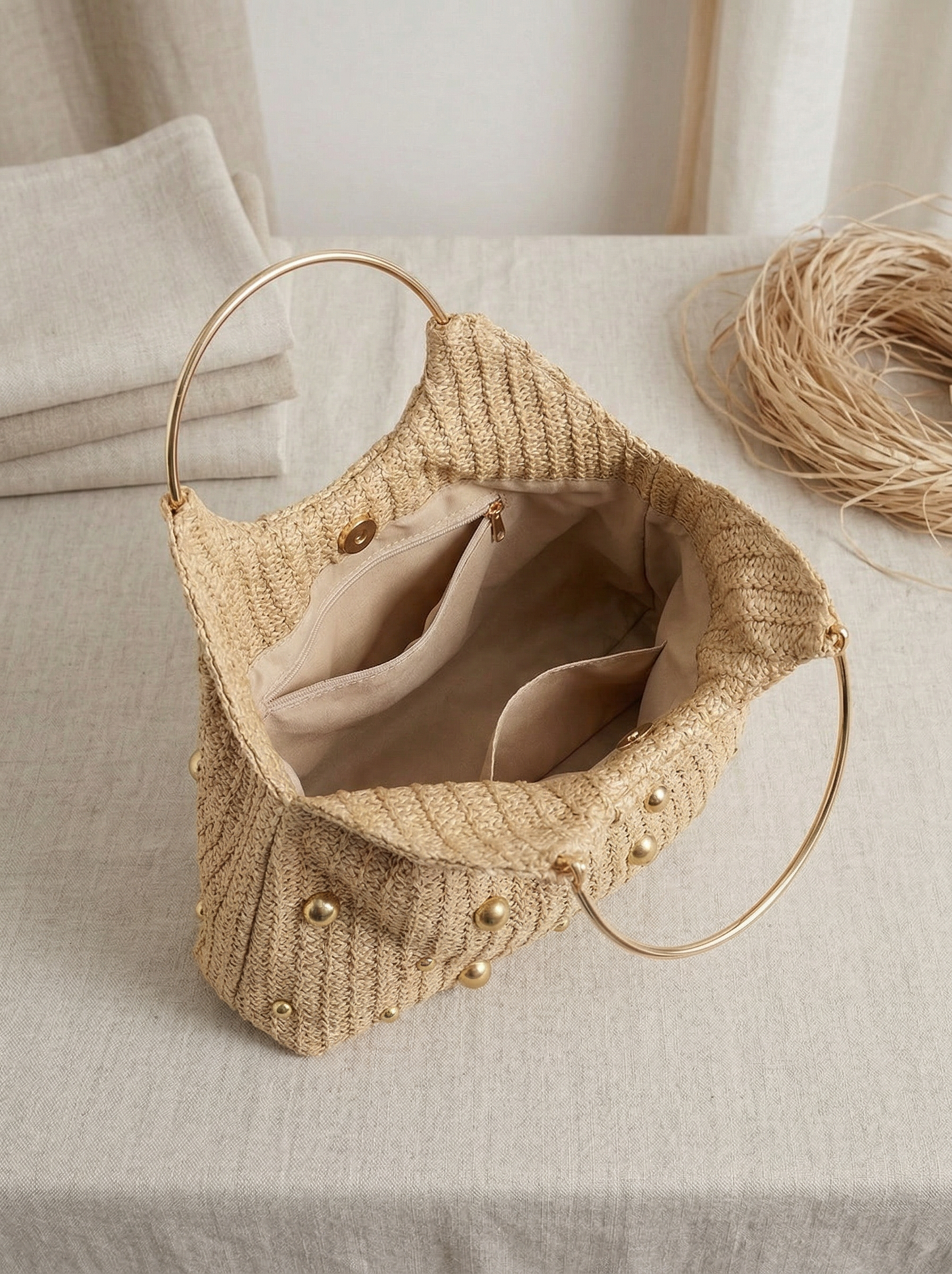 Artisanal Studded Handwoven Raffia Bag with Sculptural Gold Ring Handle