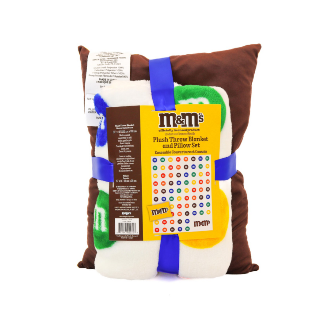 M&M's plush throw blanket and pillow set with packaging on a white background