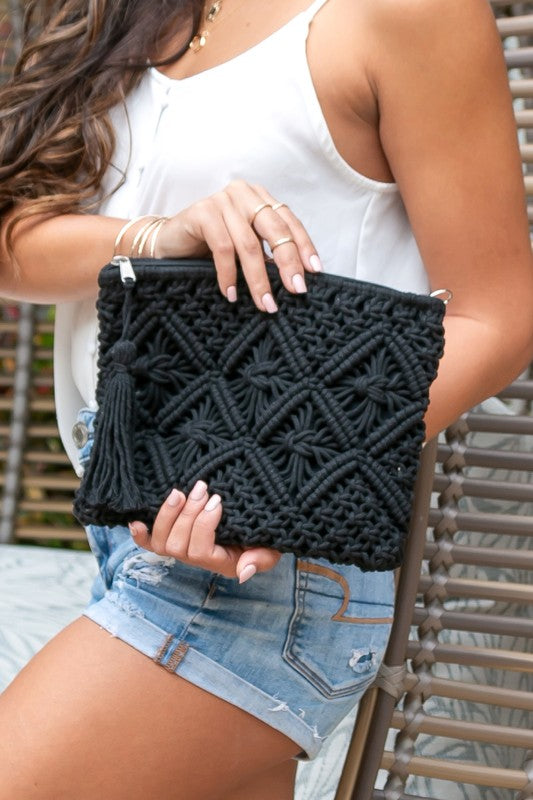 This charming macramé clutch features intricate woven detailing, a lined interior that protects your items, and a hidden open pocket Carry your essentials in soft boho-chic style. This charming macramé clutch features intricate woven detailing, a lined interior that protects your items, and a hidden open pocket for the little things. Finished with a zip closure and a playful tassel accent—perfect for nights out or travel days.

Black Macrame Tassel Clutch