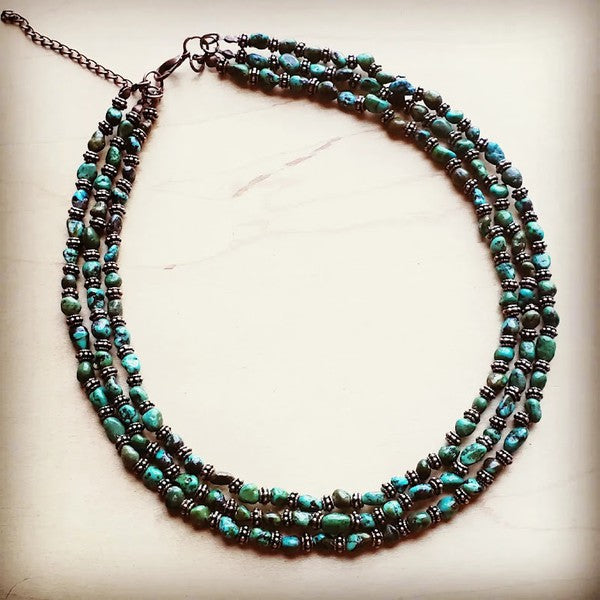 Triple Strand Turquoise & Copper Collar Necklace Triple Strand Turquoise & Copper Collar Necklace Triple Strand Turquoise & Copper Collar Necklace Make a bold statement with this stunning triple strand turquoise and copper collar necklace. Each piece features genuine gemstones in varying sizes—from delicate 1/4" accents to eye-catching 3/4" focal stones—ensuring no two necklaces are exactly alike. The adjustable 18"–24" length with extender chain adapts to your style, while the rich copper tones beautifully