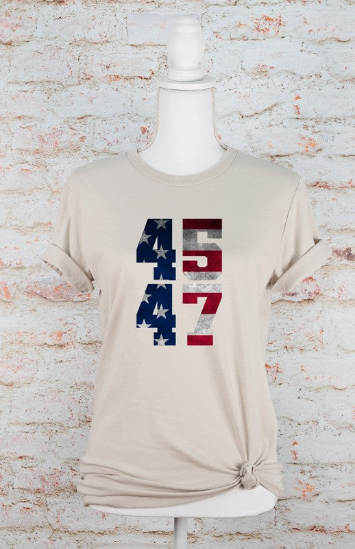 Beige t-shirt with number design on a mannequin against a textured white brick wall.