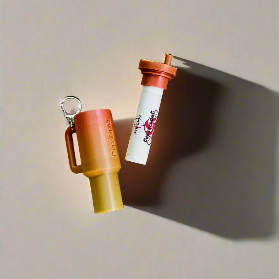 Tumbler Style Lip Balm Holder Keychain in green gradient silicone with detachable lip balm tube, key ring, and tumbler-inspired design for purses, backpacks, handbags, and keys.