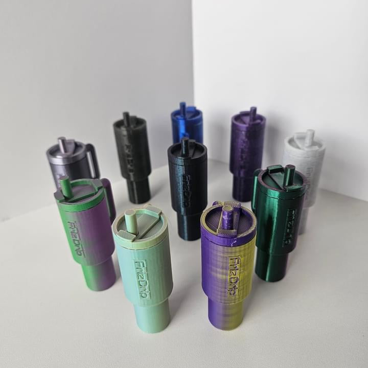 Tumbler Style Lip Balm Holder Keychain displayed in multiple vibrant colors, featuring a reusable tumbler-inspired silicone design with key rings for attaching to purses, backpacks, handbags, totes, or keys. Holds most standard lip balm tubes for convenient everyday access.