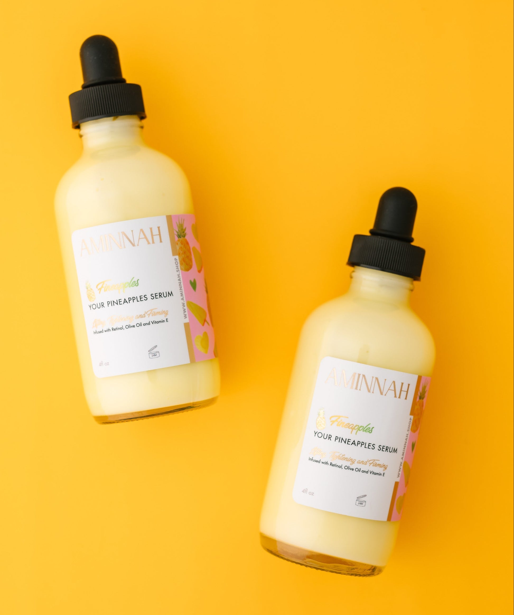Two bottles of 'Ninah' hair treatment serum on a yellow background. Pineapple and skincare products on a yellow background. Bottle of pineapple serum with a dropper on a yellow background with pineapple slices. FIneapples anti-aging skin serum Vial of pineapple cream with a pineapple