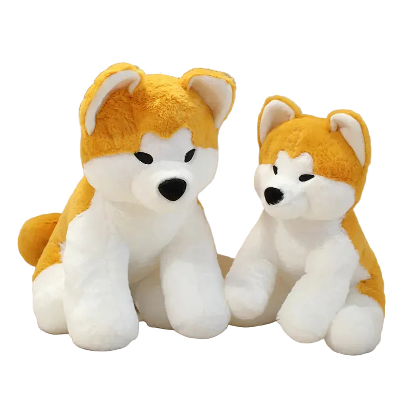 Two plush toys resembling foxes with orange backs and white fronts on a beige background.