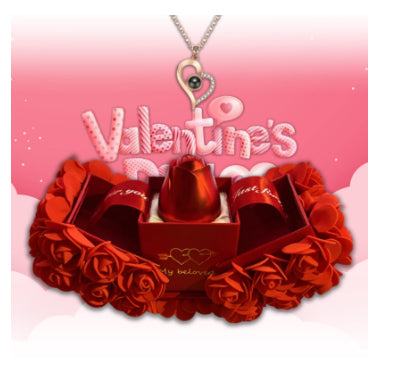 Valentine's Day gift set with red roses, chocolate, and a necklace on a pink background.