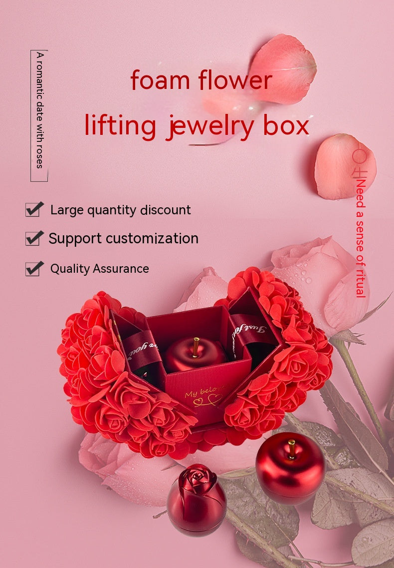 Red jewelry box with floral design on a pink background