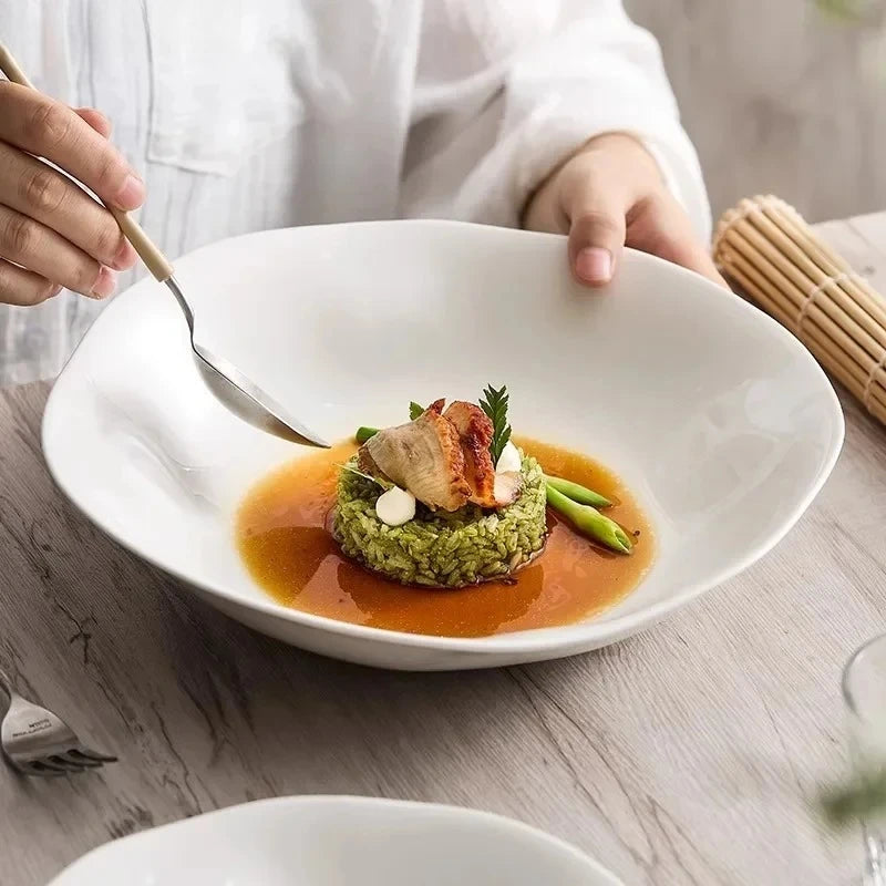 Person holding a fork over a dish of food on a wooden table