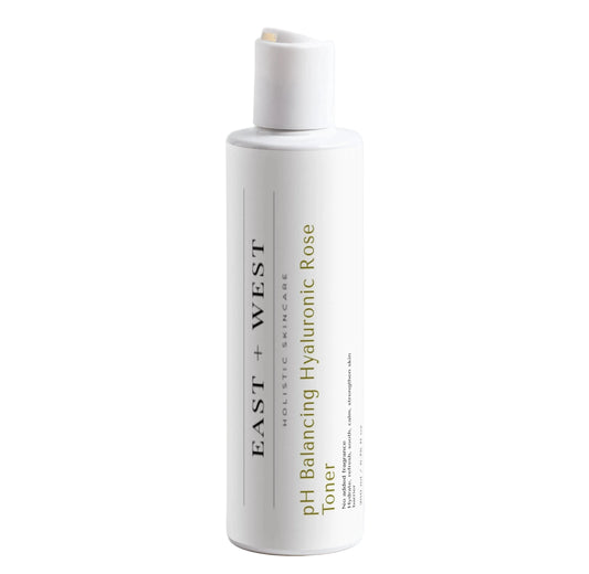 White bottle of East + West pH Balancing Hyaluronic Rose Toner on a white background