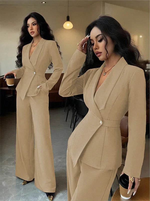Woman in a beige suit standing in a room with a blurred background long-sleeved blazer straight pants up and down two-piece set office wear women