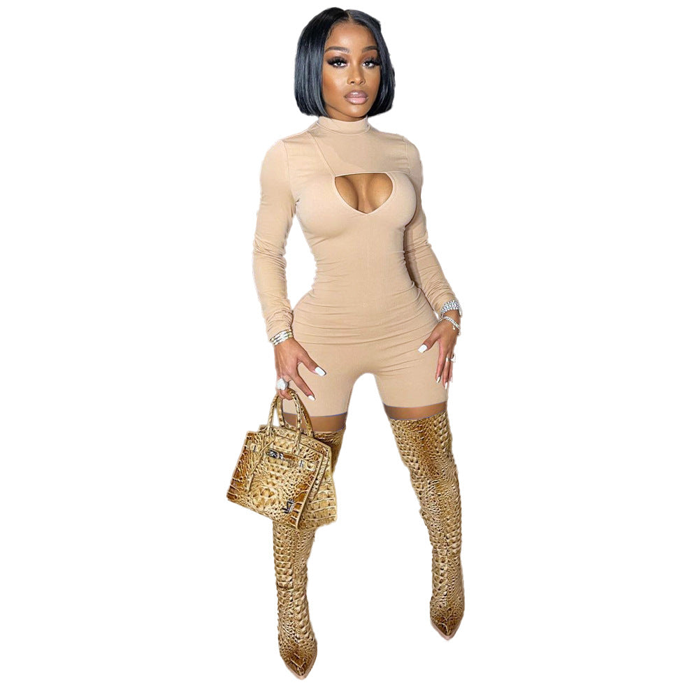 Woman wearing a beige bodysuit with cut-out design and gold high-heeled boots on a white background