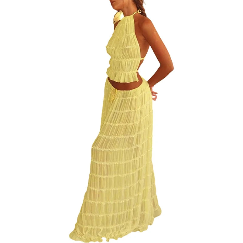 Woman wearing a yellow halter neck dress on a white background