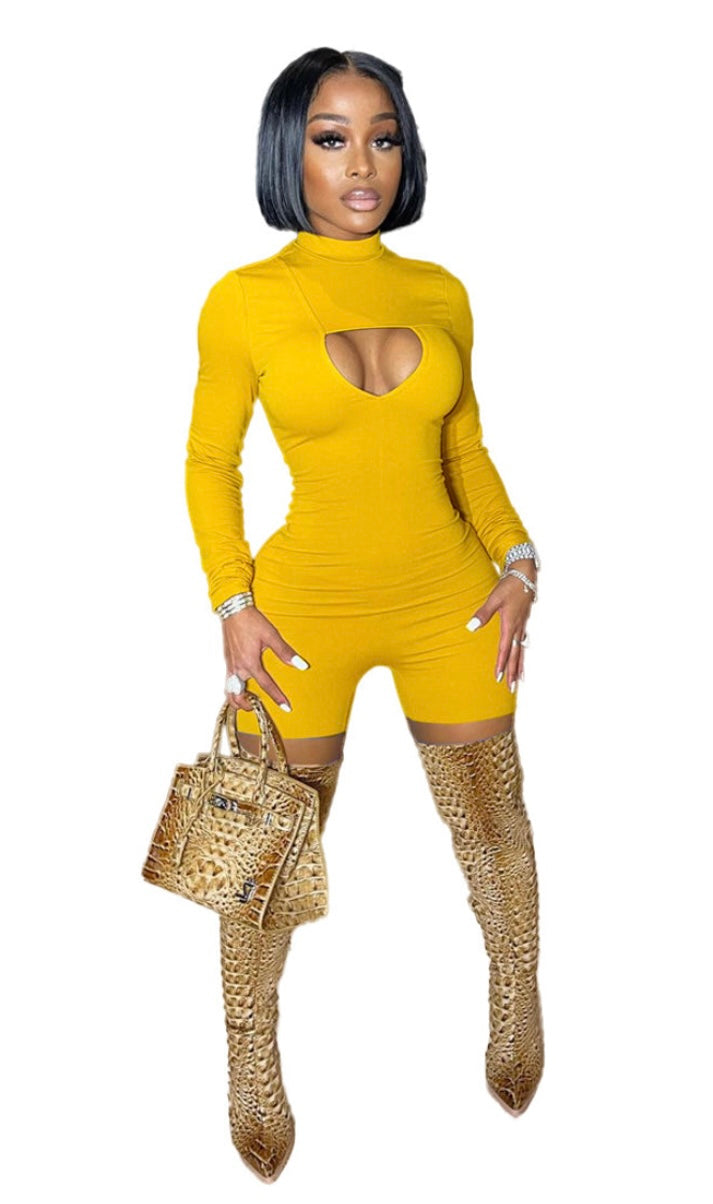 Woman wearing a yellow outfit with cut-out design and high-heeled boots on a white background
