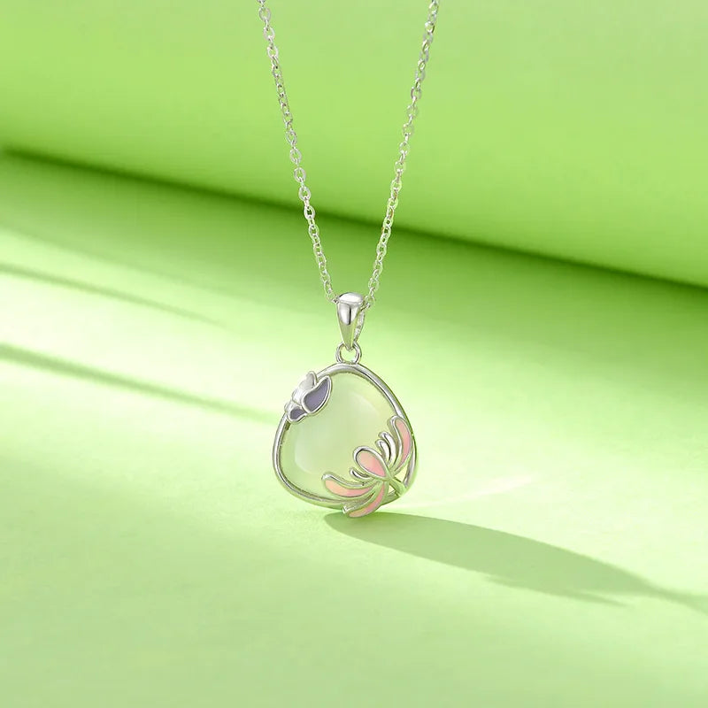 Silver necklace with a teardrop-shaped pendant on a green background. Women's  S925 Sterling Silver Necklace with Natural Turandontite Chrysanthemum Pendant Geometric Pattern Luxury Minimalist Design