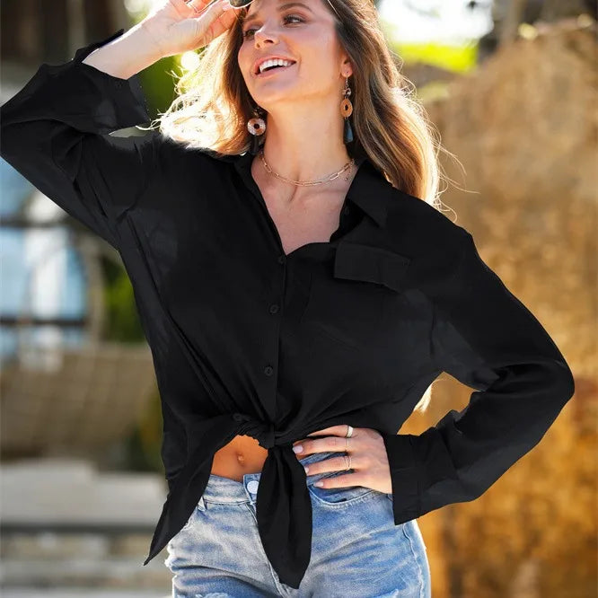 Woman wearing a black shirt with a blurred outdoor background