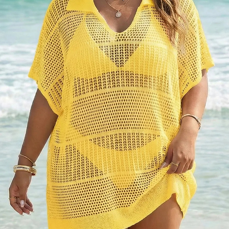 Person wearing a yellow mesh cover-up by the beach
