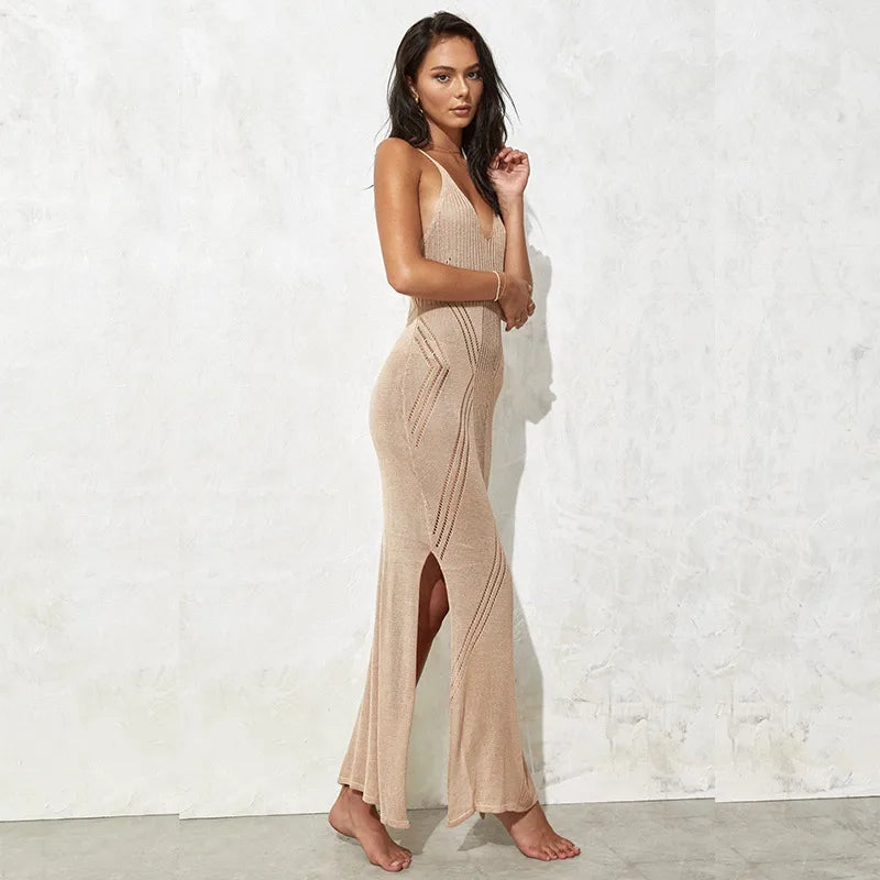 Woman wearing a beige dress with a slit standing against a white wall. beach cover up, maxi beach dress, swimsuit cover up, beach sundress, maxi sundress, women's beachwear, resort wear, vacation dress, beach dress, poolside cover up, sleeveless dress, scoop neck dress, high waist dress, summer dress, tropical vacation outfit, cruise wear, beach vacation dress, resort dress, swim cover up, lightweight dress, vacation clothing, coastal style dress, boho beach dress, women's resort wear, flowy maxi dress