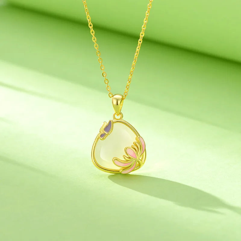 Gold necklace with a heart-shaped pendant on a green background. Women's Gold plated over S925 Sterling Silver Necklace with Natural Turandontite Chrysanthemum Pendant Geometric Pattern Luxury Minimalist Design