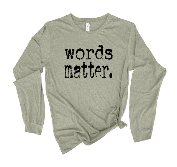 Sage green long sleeve graphic tee featuring distressed black "words matter." text across the front, displayed flat on a white background.